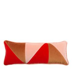 an orange and pink pillow with two red triangles on the front, sitting against a white background