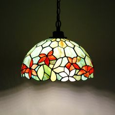 a stained glass light hanging from a chain