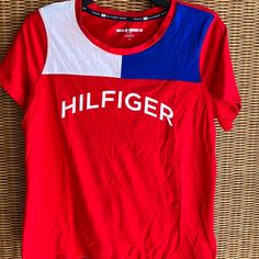 Tommy Hilfiger T Shirt. Unisex. In Excellent Shape. Never Worn. Trendy Tommy Hilfiger Cotton T-shirt, Trendy Red T-shirt With Logo Print, Tommy Hilfiger Graphic Tee With Crew Neck, Tommy Hilfiger Sporty Logo Print Tops, Casual Red Tommy Hilfiger T-shirt, Tommy Hilfiger Sporty T-shirt With Graphic Print, Tommy Hilfiger Sporty Graphic Print T-shirt, Sporty Tommy Hilfiger Tops With Graphic Print, Trendy Tommy Hilfiger Crew Neck Top