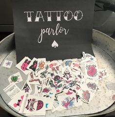 a metal tray filled with lots of different types of tattoos on top of each other