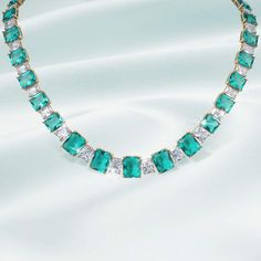 This necklace is the true embodiment of elegance and luxury. Expertly crafted and finished in luxurious yellow gold. This exquisite necklace features emerald cut, ice white and sea green Diamondeau®, flawless simulated diamond set in an alternate design. This statement piece commands attention with its bold colors and opulent design. Luxury Baguette-cut Emerald Necklace For Formal Occasions, Luxury Baguette Cut Emerald Necklace For Formal Occasions, Elegant Green Baguette Cut Emerald Necklace, Elegant Green Baguette-cut Emerald Necklace, Luxury Emerald Cut Diamond Emerald Necklace, Formal Emerald Cut Cubic Zirconia Necklace, Elegant Green Baguette Cut Necklace, Luxury Emerald-cut Emerald Diamond Necklace, Luxury Emerald Cut Brilliant Emerald Necklace