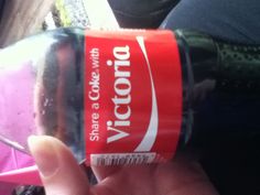 someone is holding up a coca - cola bottle with the word, share a coke with victoria