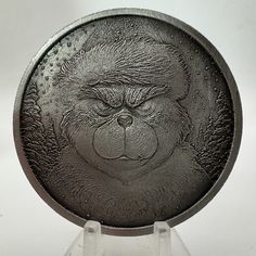 a close up of a metal object with a monkey face on it