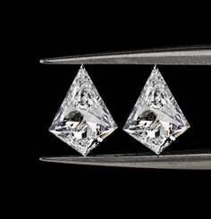 two pieces of diamond sitting next to each other on top of a metal object with a black background