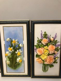 two framed pictures with flowers in them hanging on a wall next to each other,