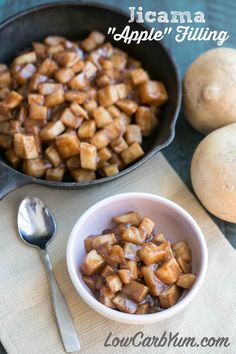 there is a bowl full of food next to some potatoes and an eggplant