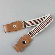 a pair of brown and white striped suspenders on a gray background with a leather clip