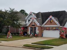 a house decorated for christmas with candy canes and decorations on the front lawn,