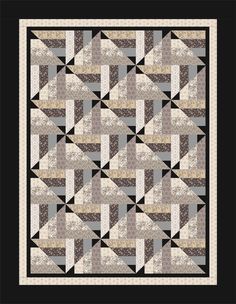 a black and white quilt with an abstract design on the front, in grey tones