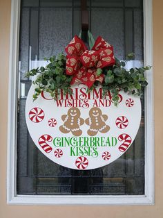 a christmas sign with gingerbread kisses and bows on it's window sill