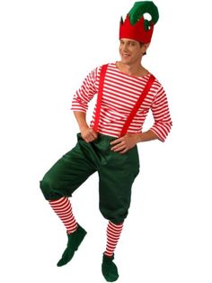 a man dressed as a christmas elf standing with his hands on his hips and legs crossed