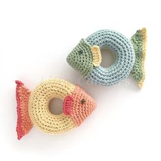 two crocheted fish toys sitting next to each other