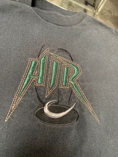 Vintage 80s AIR T Shirt Size XL See pics for measurements Quality Embroidered Logo Made in USA Black with green graphics Quality Heavy 100% cotton material Fine condition. Fast shipping. We ship same or next day with USPS We are a small family business and we appreciate your purchase, Godspeed ! Casual Streetwear Tops With Machine Embroidery, Casual Tops With Machine Embroidery For Streetwear, Casual Machine Embroidered Tops For Streetwear, 90s Embroidered Top For Streetwear, Vintage Embroidered Cotton T-shirt, Vintage Embroidered Crew Neck T-shirt, T Shirt Factory, God Speed, Embroidered Photo