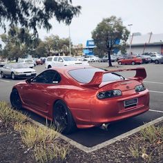 a red sports car parked in a parking lot