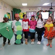 a group of people in costumes posing for a photo with one person dressed as a caterpillar