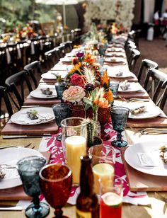 a long table is set with plates and glasses