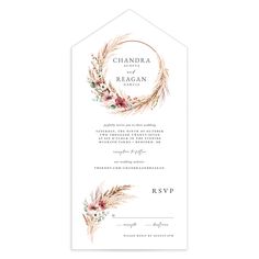 a wedding card with an elegant wreath and flowers on it