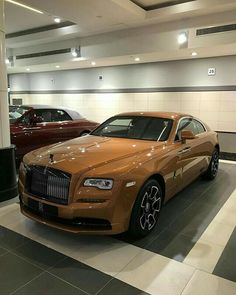 two rolls royces are parked in a showroom