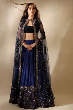 Outfit inspiration for bridesmaids | Sister of the bride outfit ideas | Navy blue lehenga with golden mirror work at bottom | Long cape jacket in place of dupatta | Trending outfits for Indian  bridesmaids | Bride's BFFs | Outfit by Astha Narang | Every Indian bride’s Fav. Wedding E-magazine to read. Here for any marriage advice you need | www.wittyvows.com shares things no one tells brides, covers real weddings, ideas, inspirations, design trends and the right vendors, candid photographers etc Modern Lengha, Cape Dress Fashion, Blue Lengha, Astha Narang, भारतीय दुल्हन संबंधी, Orang India, डिजाइनर कपड़े, Baju Kahwin, Cape Outfit