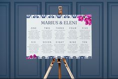 an easel with a sign on it in front of a blue wall that says marbus & elenii