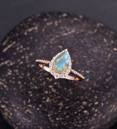 Vintage Labradorite engagement ring Pear shaped Rose gold ring milgrain art deco moissanite ring unique art deco ring anniversary ring Back to Belloring shop: https://www.etsy.com/shop/BrilliantRing?ref=l2-shopheader-name ---------------------------Specifications---------------------- Engagement ring Center Stone - 6*9mm pear cut Labradorite Side stones - 0.323ct Moissanite or Diamond ---------------------------DIMENSIONS----------------------- The Width of the Band - 1.4mm The Thickness of the Teardrop Bezel Setting Promise Ring, Teardrop Bezel Setting Jewelry For Promise Ring, Unique Anniversary Jewelry With Halo Setting, Unique Jewelry With Halo Setting For Anniversary, Pear-shaped 14k Gold Gemstone Wedding Ring, Pear-shaped Moissanite Jewelry With Prong Setting, Delicate Pear-shaped Diamond Accent Jewelry, Unique Pear-shaped Wedding Jewelry, Delicate Pear-shaped Jewelry With Diamond Accents