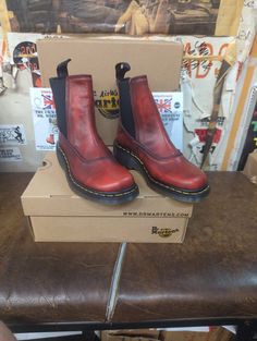 These are a rare pair of Dr Martens boots. These are an older, original, Made in England Chelsea boot. They are an unusual version as they have a different stitched upper and an all in one piece wedged sole. The upper is a lovely burnished Red leather.  These are a uk size 4, European 37, ladies USA 6. Streetwear Boots With Round Toe And Vibram Sole, Retro Boots With Rubber Sole And Round Toe, Streetwear Leather Sole Closed Toe Boots, Retro Boots With Leather Sole And Round Toe, Retro Ankle Boots With Leather Sole, Retro High-top Boots With Rubber Sole, Vintage Ankle Boots With Rubber Heel Cap, Red Boots With Leather Sole For Outdoor, Retro Leather Boots With Reinforced Heel