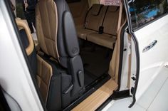 the interior of a car with its door open and seats folded down in front of it