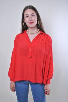 Elevate your wardrobe with this 90s minimalist red blouse, a vintage gem from TARASCOMMON.ETSY.COM! This blouse features a timeless design that exudes elegance and sophistication. The loose, lightweight fit makes it perfect for everyday wear, while the puff sleeves add a touch of vintage charm. Made from viscose and crafted in France, this blouse offers both quality and style. The bold red color is sure to make a statement, whether you're dressing up for a night out or adding a pop of color to y Red Relaxed Fit Long Sleeve Blouse, Red Relaxed Fit Blouse For Work, Chic Red Blouse With Relaxed Fit, Red Balloon Sleeve Tops For Fall, Trendy Red Puff Sleeve Blouse, Red Collared Blouse With Relaxed Fit, Red V-neck Blouse Relaxed Fit, Red Relaxed Fit Tops For Work, Relaxed Fit Red Top For Workwear