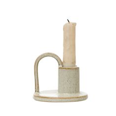 a white candle holder with a handle on it