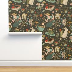 the wall paper is decorated with an image of mermaids and other sea creatures on black