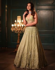 This pistachio green lehenga set features all-over sequin, crystal, cutdana, and bead embroidery. Paired with a dramatic feathered dupatta and strappy corset blouse embroidered with sequin and crystal detailing on net.DELIVERY TIMEPlease allow 8-12 weeks for your outfit to arrive.FABRIC DETAILSNetProfessional cleaning only. Pista Green Anarkali Set With Sequins, Designer Pista Green Choli With Sequins, Pista Green Sequined Choli For Designer Wear, Designer Pista Green Sequined Choli, Pista Green Sequined Anarkali Set For Party, Pista Green Lehenga With Sequins For Wedding, Pista Green Sequin Sets For Reception, Bollywood Style Pista Green Sequined Lehenga, Anarkali Lehenga In Pista Green With Sequins