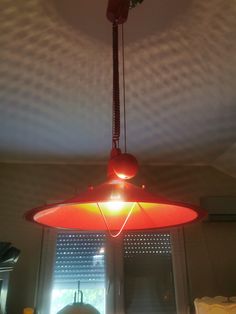 a red light hanging from the ceiling in a room