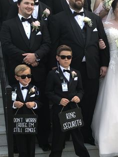 a group of people standing next to each other wearing suits and ties with signs on them