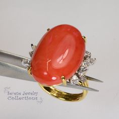 This rare Japanese Momo Coral Ring is set in 18k solid gold. 6 round diamonds and 4 marquise diamonds surround the coral. Ring Size: 6 Total Weight: 11.7 grams Precious Metal: 18k solid gold Precious stones: -Coral Center Stone: 25.5mm x 17.8mm -White Round and Marquise Diamonds Elegant Oval Coral Rings, Elegant Coral Oval Rings, Formal Coral Ring, Elegant Coral Ring Jewelry, Elegant Coral Rings For Anniversary, Luxury Round Coral Jewelry, Elegant Coral Jewelry For Anniversary, Coral Elegant Wedding Rings, Elegant Coral Wedding Rings