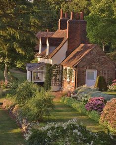 the country cottage in old halffield is surrounded by flowers and trees