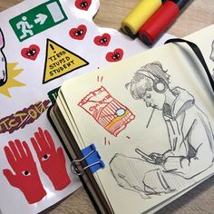 some drawings and markers on a table