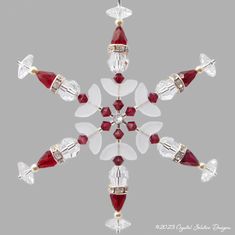 a red and white snowflake ornament on a gray background