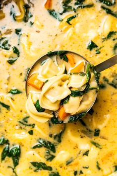 a spoon full of pasta and spinach soup