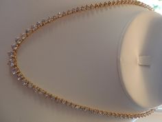 "ALL HANDMADE 14K SOLID YELLOW GOLD NECKLACE WITH 105 GRADUATED ALL NATURAL, MINED WHITE SAPPHIRES - NOT LAB CREATED. GUARANTEED. RECENTLY APPRAISED BY A GIA GRAD GEMOLOGIST. ABSOLUTELY STUNNING, WORN ONLY A HANDFUL OF TIMES. I AM THE SOLE OWNER. IT HAS A SECURE TONGUE CLASP CLOSURE & WRAP-AROUND CATCH THAT SNAPS SHUT TIGHTLY FOR ADDITIONAL SECURITY. Approximately 57 carats total of sapphires. Largest stone approx. 6 mm and smallest approx. 2.5mm. VS clarity. Total gram weight for the neckla Formal 14k Yellow Gold Tennis Necklace, Gold Round Tennis Necklace For Gift, 14k Gold Tennis Necklace, Gold Tennis Necklace With 17 Jewels As A Gift, Gold Cubic Zirconia Bridal Necklace With Diamond Cut, Luxury Gold Bridal Necklace For Anniversary, Gold Elegant Tennis Necklace With Diamond Cut, Gold Diamond Cut Elegant Tennis Necklace, Gold Tennis Necklace With Diamond Accents As A Gift