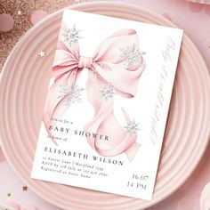 a baby shower card on a pink plate