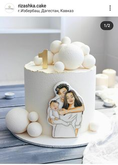 a wedding cake with an image of the bride and groom on it, surrounded by white balls