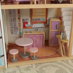 a doll house with furniture and accessories inside