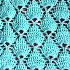 a blue crocheted blanket with holes in the middle