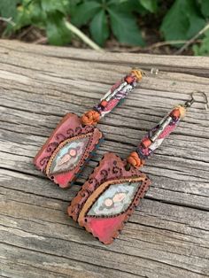 "These are an original, one of a kind, Zasra design. This listing is for the painted wooden rectangle shaped , mixed media fiber dangle earrings. For this pair I have hand painted them, and did a mixed media, leaf/ third eye design. I also hand stitched the fiber focal design, and hand beaded. Beaded onto a antique brass earwire. Measurements ~ light to mid weight length ~ 3.5\"( including ear wire) width 1\"" Handmade Rustic Earrings For Jewelry Making, Rustic Handmade Earrings For Jewelry Making, Artistic Brown Jewelry For Festival, Handmade Brown Earrings For Festival, Rustic Dangle Earrings For Festivals, Artsy Artistic Design Earrings For Festivals, Unique Artistic Design Earrings For Festival, Adjustable Bohemian Earrings With Artistic Design, Artisan Earrings With Artistic Design For Festivals