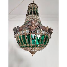 an ornate green chandelier hanging from the ceiling