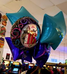 balloons and streamers in the shape of numbers are on display at an indoor casino