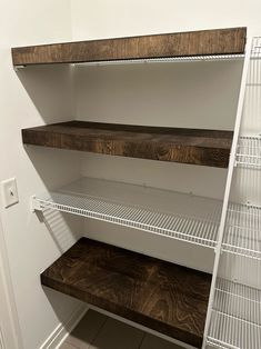 an empty pantry with shelves and wire shelving