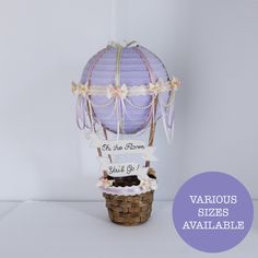 a purple hot air balloon sitting on top of a basket