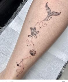 a woman's leg with a tattoo on it and an image of a sea turtle