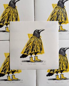 four black and yellow birds sitting on top of each other in front of white paper